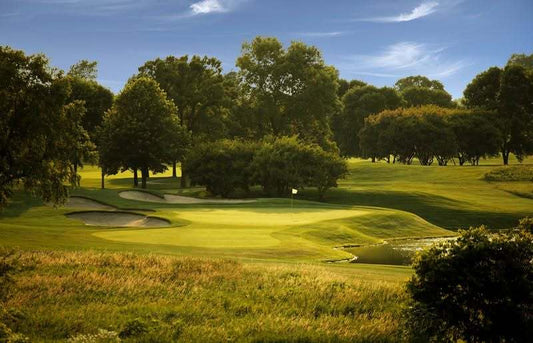 The par-3 eighth hole at Hazeltine National Golf Club features a tightly guarded green with sand left and water right, creating one of the precision tests players will face this week at the KPMG Women’s PGA Championship.