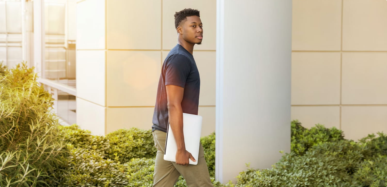 An image of a student walking into a university building