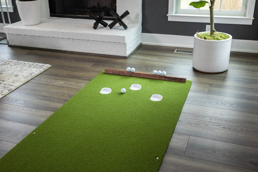 Elevated view of the mat laid out in a living room, walnut backstop and golf balls in place