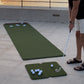 Roll-out putting mat laid flat on a seaside terrace at sunset, with a golfer putting from a hitting mat